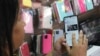 Ana Claudia, a salesperson at a cell phone case store located inside the bus station, shows the last X post she received before the social media platform was blocked nationwide in Brasilia, Brazil, Sept. 2, 2024. 