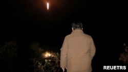 FILE - North Korean leader Kim Jong Un looks on as a rocket carrying a spy satellite Malligyong-1 is launched in a location given as North Gyeongsang Province, North Korea in this handout picture obtained by Reuters, Nov. 21, 2023.