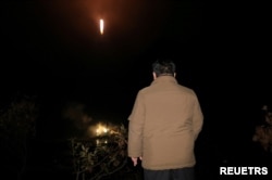 FILE - North Korean leader Kim Jong Un looks on as a rocket carrying a spy satellite is launched in a location given as North Gyeongsang Province, North Korea in this handout picture obtained by Reuters, Nov. 21, 2023.