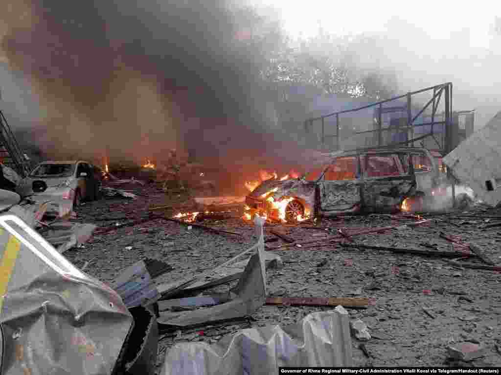 Firefighters work at a site in an area damaged during a Russian missile strike in Rivne, Ukraine.