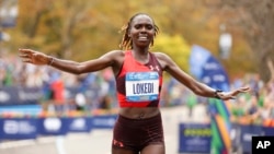 FILE - Sharon Lokedi, of Kenya, crosses the finish line first in the women's division of the New York City Marathon, Nov. 6, 2022, in New York. 