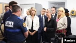 French Prime Minister Elisabeth Borne (second right) and other officials meet with municipal police, after rioters rammed a vehicle into the house of L'Hay-les-Roses mayor, at the City Hall in L'Hay-les-Roses, south of Paris, July 2, 2023.