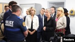 French Prime Minister Elisabeth Borne (second right) and other officials meet with municipal police, after rioters rammed a vehicle into the house of L'Hay-les-Roses mayor, at the City Hall in L'Hay-les-Roses, south of Paris, July 2, 2023.