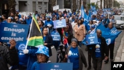 Supporters of the Democratic Alliance, South Africa's main opposition party, march through the streets to protest employment quotas along racial lines, in Cape Town, July 26, 2023. 