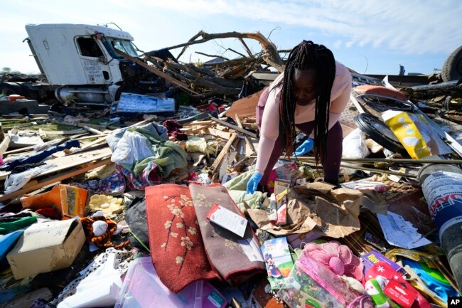 Kimberly Patton surveys through the belongings at the spot of a family member's home after a tornado destroyed the property March 26, 2023, in Rolling Fork, Miss.(AP Photo/Julio Cortez, File)