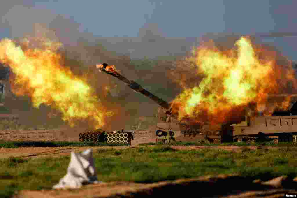 An Israeli mobile artillery unit fires towards Gaza, amid the ongoing conflict between Israel and the Palestinian Islamist group Hamas, near the Israel-Gaza border, in Israel.