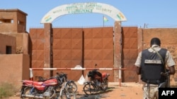 FILE - A Nigerien gendarme stands near assailants' motorcycles outside the Koutoukale prison near Niamey, following an attack on Oct. 17, 2016. Inmates escaped from the prison on July 11, 2024, though officials did not say how or how many.