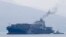 FILE - Cargo ship M/V Bavaria is assisted by tug boats as it prepares to dock at Subic port, Philippines, May 30, 2019. The head of the United Nations called Monday for maritime nations to chart a course for the shipping industry to reduce its climate-harming emissions.
