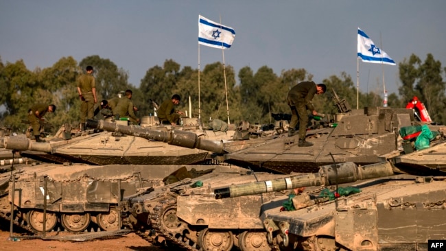 Israeli battle tanks are deployed at a position along the border with the Gaza Strip and southern Israel on Dec. 31, 2023.