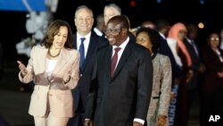 U.S. Vice President Kamala Harris talks with Tanzania's Vice President Philip Mpango as she arrives at the Julius Nyerere Airport in Dar es Salaam, Tanzania, March 29, 2023.