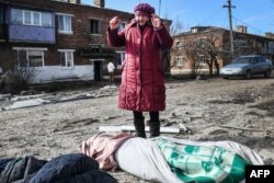 A woman mourns the victims of a missile strike in the town of Panteleimonovka in a Russian-controlled part of Donetsk region, Feb. 17, 2024.