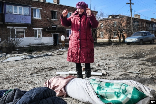 A woman mourns the victims of a missile strike in the town of Panteleimonovka in a Russian-controlled part of Donetsk region, Feb. 17, 2024.