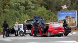 Polisi Kosovo menggeledah kendaraan di persimpangan jalan menuju Biara Banjska selama operasi yang sedang berlangsung di desa Banjska, Kosovo, 25 September 2023.