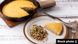 Hoppin' John, made with black-eyed peas, is a traditional New Year's Day food tradition that originated in the American South. Cornbread, which is the color of gold, is supposed to bring riches.