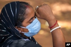 A woman whose husband died in Friday's train accident waits outside a mortuary at the All India Institute of Medical Sciences hospital in Bhubaneswar in the eastern state of Orissa, India, June 5, 2023.