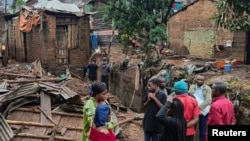 People stand by the damage in the aftermath of deadly floods caused by torrential rains in Bukavu, Democratic Republic of Congo, Dec. 27, 2023.