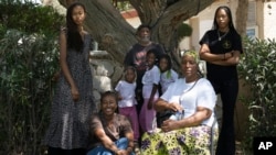 Members of three families from the Africaebrew Israelites of Jerusalem community facing deportation, pose for a portrait in the Village of Peace in Dimona, Israel, July 17, 2023.