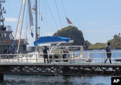 Investigators from Grenada and St. Vincent and the Grenadines are seen aboard the yacht "Simplicity," now anchored at the St. Vincent and the Grenadines Coastguard Service Calliaqua Base, in Calliaqua, Feb. 23, 2024.