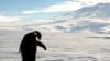 FILE - A foraging emperor penguin preens on snow-covered sea ice in Antarctica, Dec. 9, 2006. 