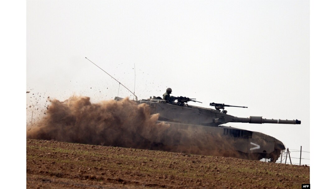 A picture taken in southern Israel near the border with the Gaza Strip on Dec. 7, 2023, shows an Israeli army tank rolling in a field amid continuing battles between Israel and the militant group Hamas.