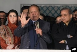Pakistani former Prime Minister Nawaz Sharif, center, addresses supporters following initial results of the country's parliamentary election, in Lahore, Pakistan, Feb. 9, 2024. Sharif said Friday he will seek to form a coalition government.