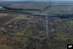 FILE - This drone image on Sept. 6, 2023, shows houses seen destroyed during the fighting between Russian and Ukrainian armed forces are seen in Andriivka, Donetsk region, Ukraine.