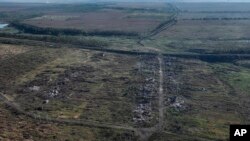 FILE - This drone image on Wednesday Sept. 6, 2023, shows houses seen destroyed during the fighting between Russian and Ukrainian armed forces are seen in Andriivka, Donetsk region, Ukraine.