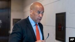 FILE - Sen. Cory Booker departs after a briefing on Capitol Hill, in Washington, April 19, 2023. Booker has joined a growing list of Democrats calling on Sen. Bob Menendez to resign.