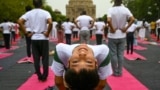 People take part in a yoga session at Lodhi gardens on International Day of Yoga, in New Delhi.