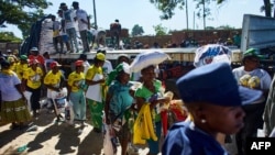 Supporters of the Zimbabwe ruling party The Zimbabwe African National Union Patriotic Front (ZANU-PF) receive food parcels as they arrive at an election campaign rally for aspiring member of Parliament Mabvuku, Tafara constituency, in Harare, on Dec. 7, 2023.