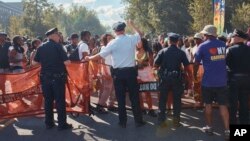 Police move revelers from the street after a shooting on Eastern Parkway, near the corner of Franklin Avenue, during the West Indian Day Parade, Sept. 2, 2024, in the Brooklyn borough of New York.