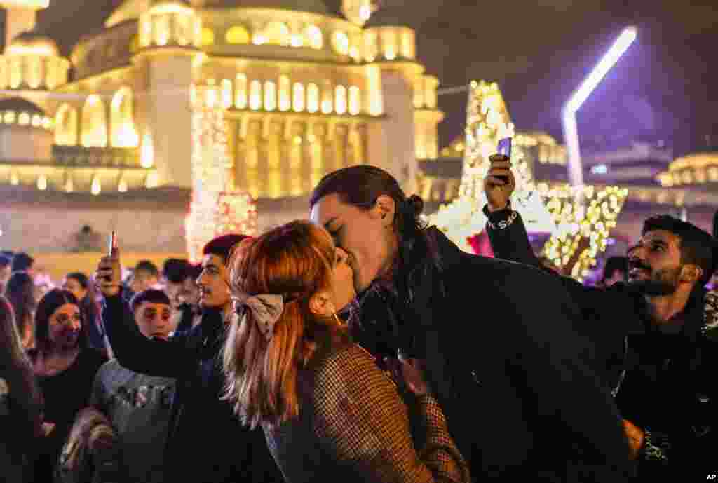 A couple kisses celebrating the New Year in Taksim Square, Istanbul, Turkey, Jan. 1, 2024.