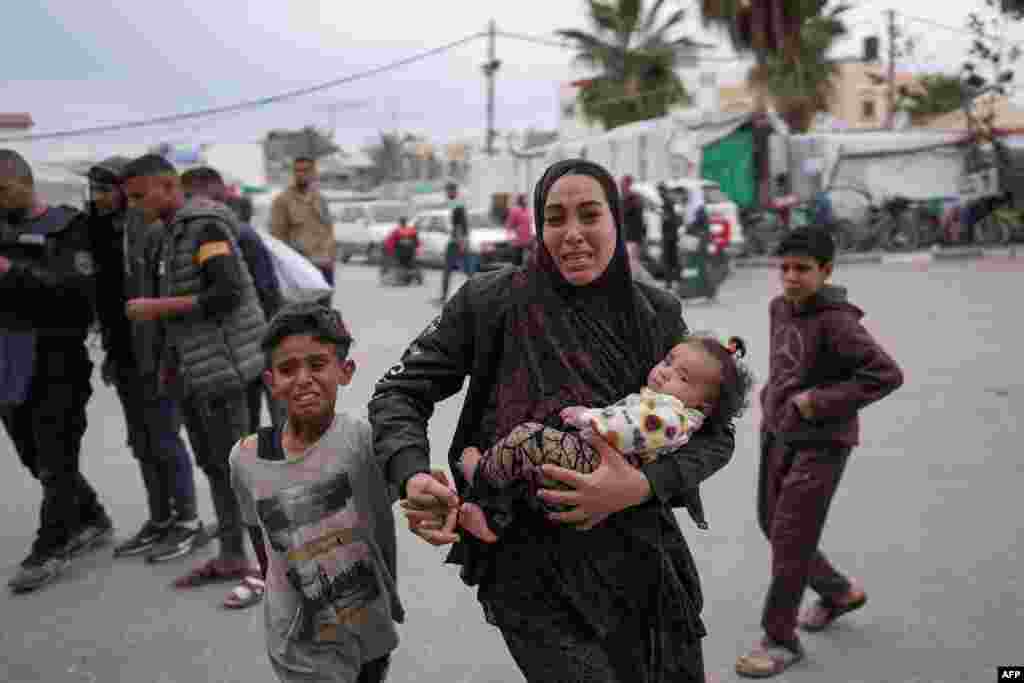 Palestinians react at a hospital where casualties of Israeli bombardment on al-Bureij camp in the central Gaza Strip were transported.