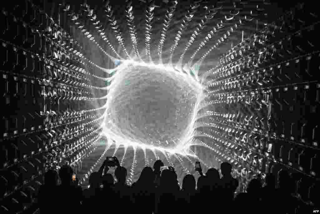 Visitors watch a light display during a tour of the new location for the digital art of Japanese collective &quot;teamLab&quot; at the recently opened 325-metre Azabudai Hills tower in Tokyo.