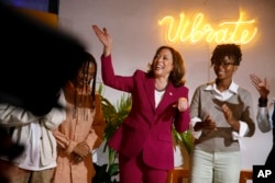 U.S. Vice President Kamala Harris, flanked by Ghana upcoming artist Baaba J, right, visits the Vibration studio at the freedom skate park in Accra, March 27, 2023.