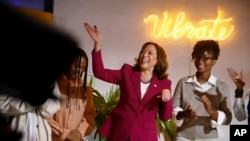 U.S. Vice President Kamala Harris, flanked by Ghana upcoming artist Baaba J, right, visits the Vibration studio at the freedom skate park in Accra, March 27, 2023.