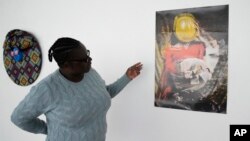 Fadzai Muchemwa, National Art Gallery curator, looks at Nothando Chiwanga's art piece, "Immortal", in Harare, Friday, April, 14, 2023. Chiwanga's "Immortal" is one of 21 works by female artists that have been on show at the southern African country's national gallery