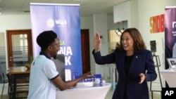 U.S. Vice President Kamala Harris shares a light moment with Tanzanian climate entrepreneur Gibson Kiwago at the SNDBX Space, a space for freelancers, entrepreneurs, builders, innovators and creatives, in Dar es Salaam, Tanzania, March 30, 2023.