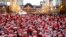 Participants wearing Santa Claus outfits pose for photos before their event to hand out gifts and clean up the street to celebrate the upcoming Christmas season in Tokyo, Japan.
