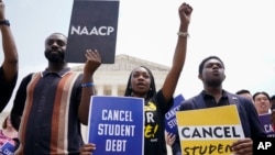 Jordan Braithwaite, 21, center, an undergrad at Grambling State University facing more than $10,000 in student loans, demonstrates outside the US Supreme Court, June 30, 2023, in Washington. 