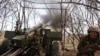 A Ukrainian soldier fires a howitzer at Russian positions near Kremenna, Luhansk region, Ukraine, April 5, 2023. U.S. officials are racing to remove leaked documents related to the war from social media platforms.