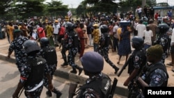 FILE - Nigerian police patrol as anti-government demonstrations against bad governance and economic hardship continue, in Lagos, Nigeria, Aug. 5, 2024.