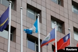 An empty flag pole where the Honduran flag used to fly is pictured next to flags of other countries at the Diplomatic Quarter which houses embassies in Taipei, Taiwan, March 26, 2023.