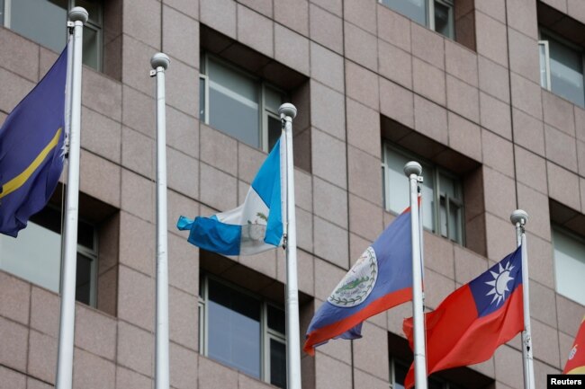 An empty flag pole where the Honduran flag used to fly is pictured next to flags of other countries at the Diplomatic Quarter which houses embassies in Taipei, Taiwan, March 26, 2023.