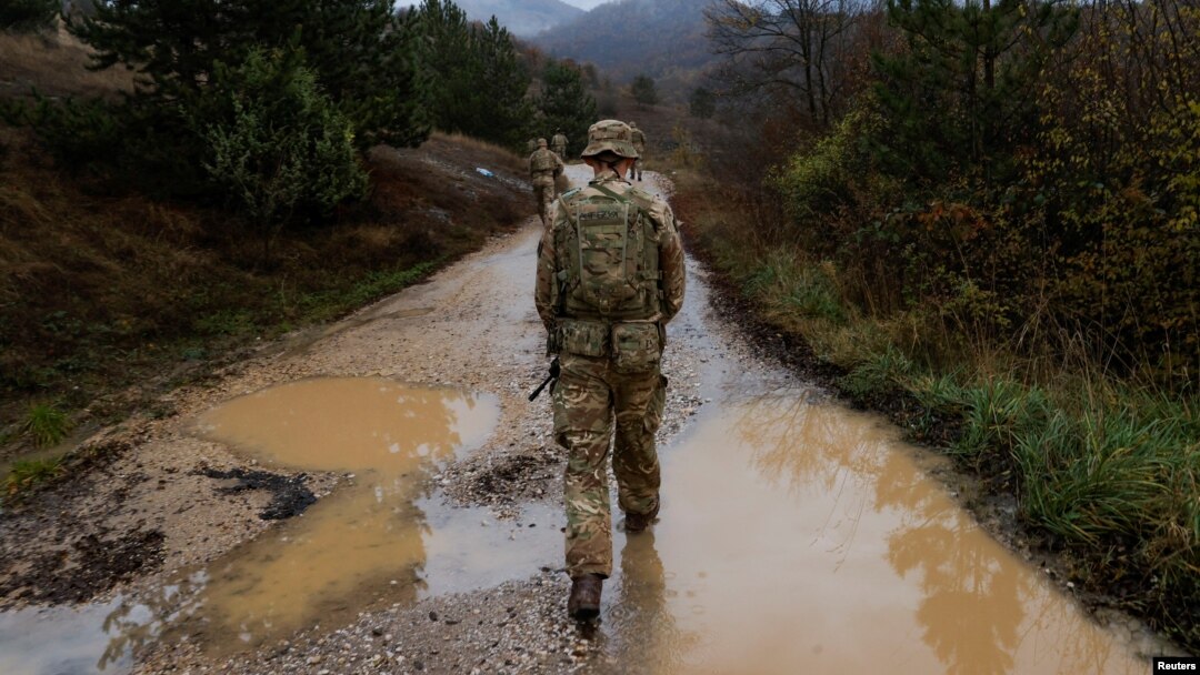 FILE - British troops patrol the Kosovo-Serbia border in Jarinje, Kosovo, Nov. 24, 2023. Twenty-five years ago, NATO launched an air campaign to stop ethnic cleansing by Serbian forces against ethnic Albanians in Kosovo, then a province of Serbia in the former Yugoslavia. 