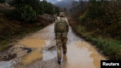 FILE - British troops patrol the Kosovo-Serbia border in Jarinje, Kosovo, Nov. 24, 2023. Twenty-five years ago, NATO launched an air campaign to stop ethnic cleansing by Serbian forces against ethnic Albanians in Kosovo, then a province of Serbia in the former Yugoslavia. 