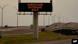 A sign notifies motorists to prepare for Hurricane Beryl, July 7, 2024, in Portland, Texas. 