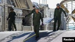 Japan Maritime Self Defense Force personnel unload supplies from a landing craft on Bellows Beach during a joint exercise between Japan and the Peruvian navy at the Rim of the Pacific (RIMPAC) military exercises in Waimanalo, Hawaii, July 18, 2024.