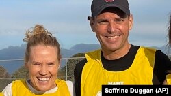 This undated photo shows Dan Duggan, right and his wife, Saffrine. Dan Duggan, a former U.S. military pilot, had his extradition hearing on U.S. charges he illegally trained Chinese aviators postponed on July, 25, 2023. (Photo courtesy of Saffrine Duggan via AP).