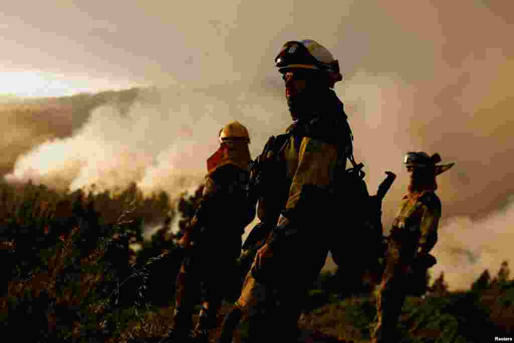 EIRIF forest firefighters work during the extinction of the Tijarafe fire on the Canary Island of La Palma, Spain, July 16, 2023.